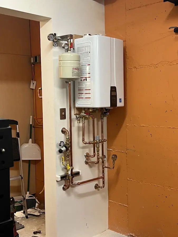 Plumbing technician inspecting water heater connections in Palm Beach Gardens